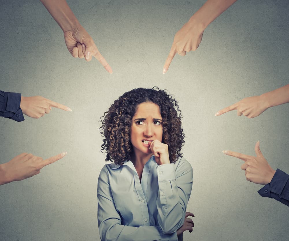 Fingers pointing at a woman