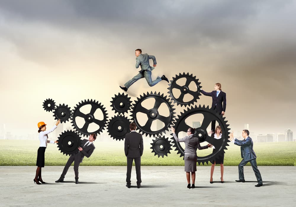 Businesspeople interacting with fictional gears