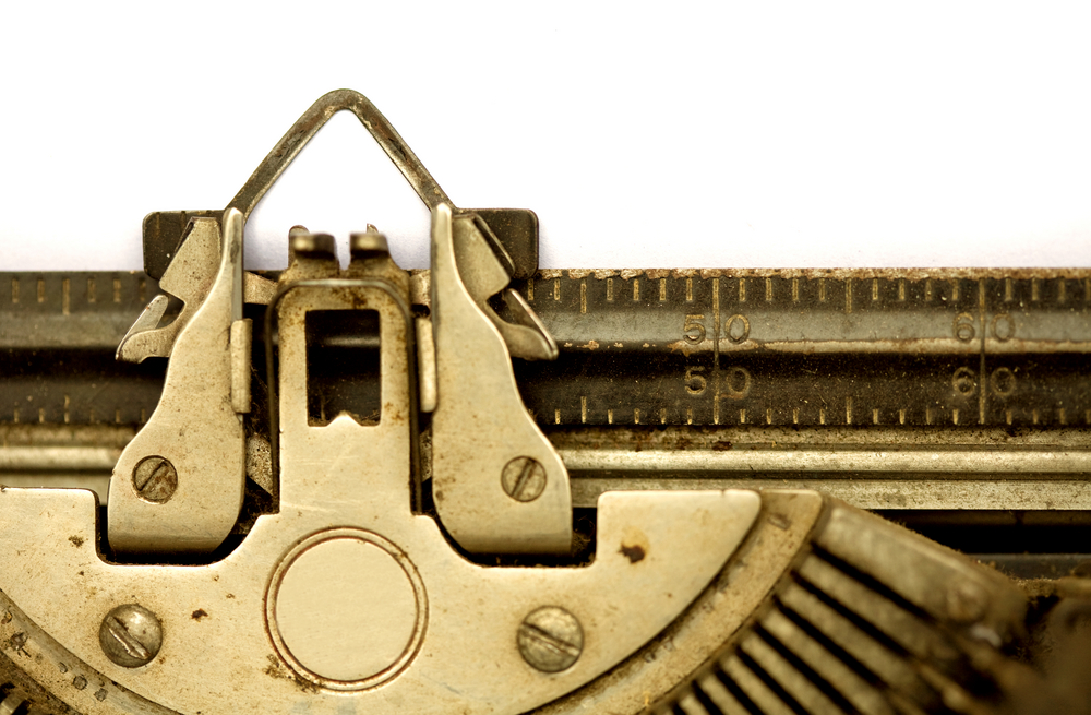 A zoomed in photo of a typewriter without any text yet written