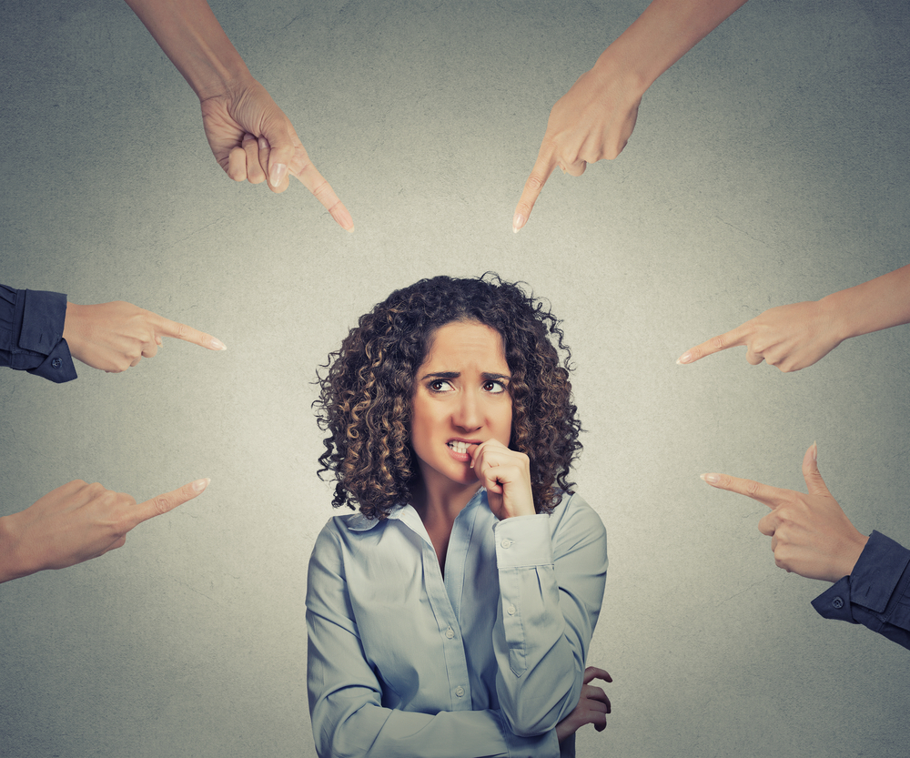 Fingers pointing at a woman