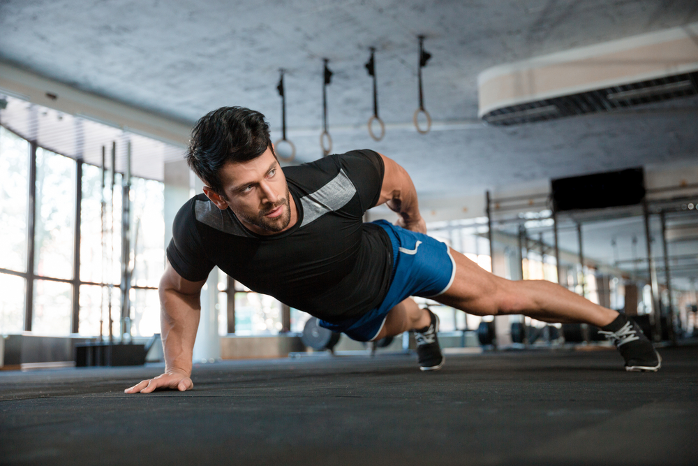 A man doing a one-handed pushup