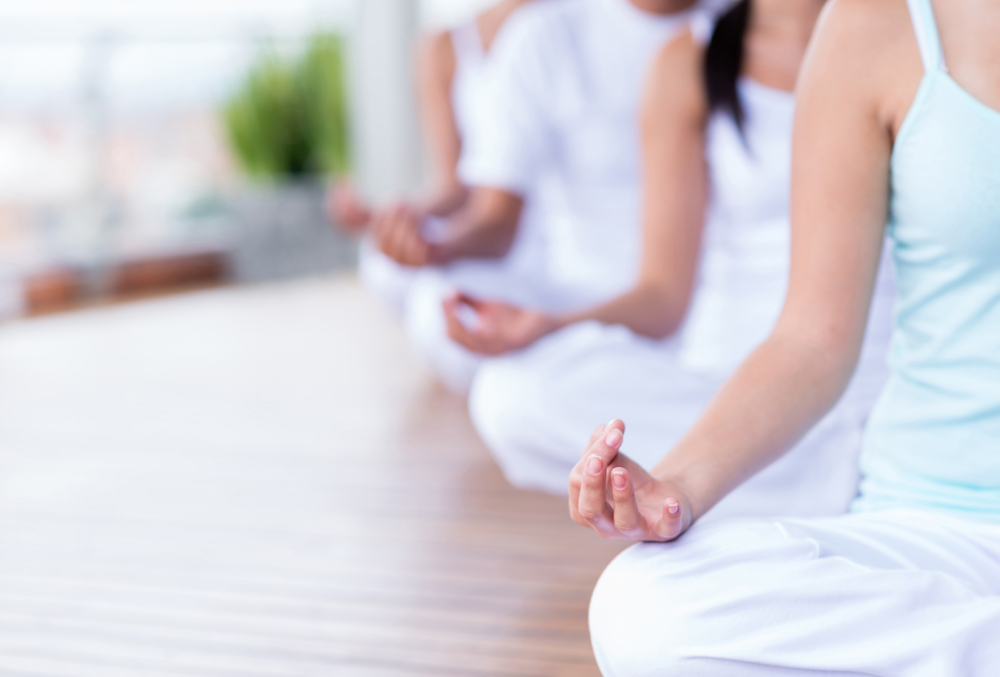 people meditating in a line