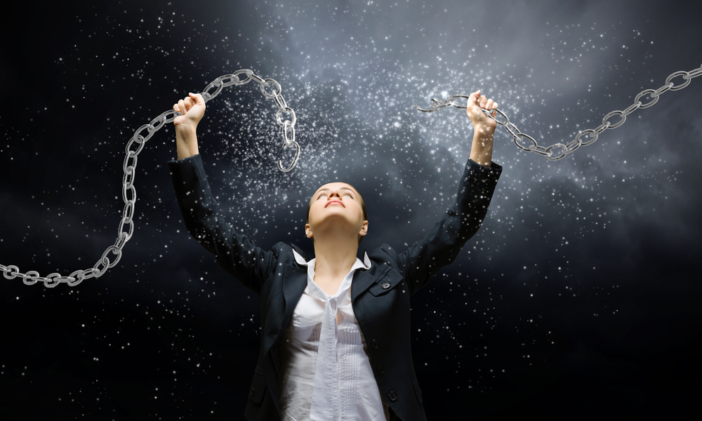 A woman breaking a chain held above her head