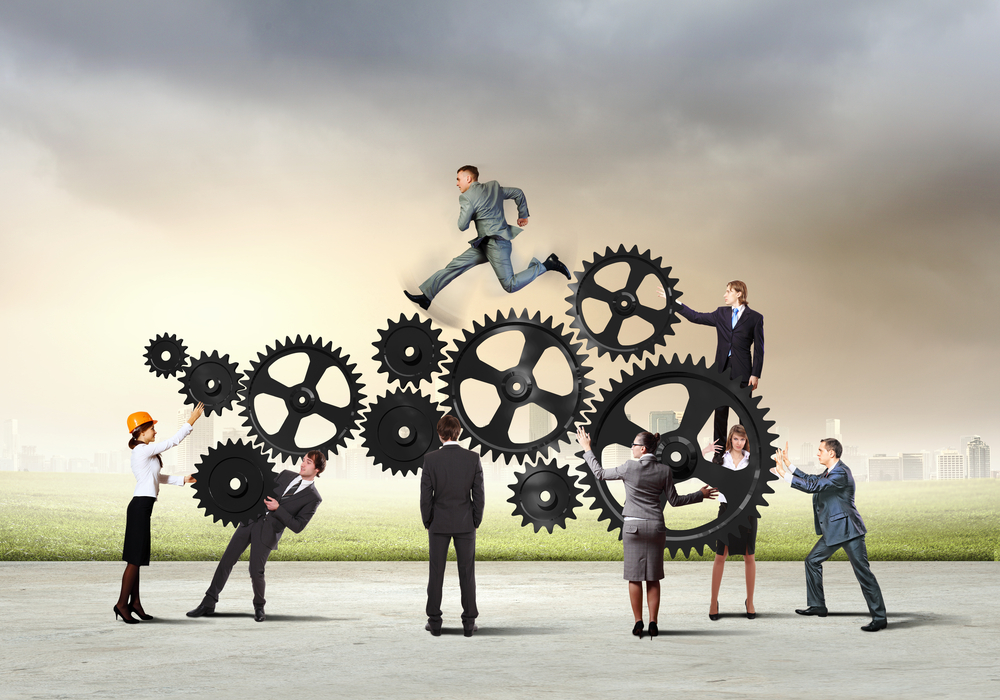 Businesspeople interacting with fictional gears