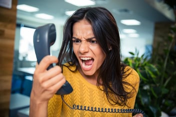 A woman yelling into a phone