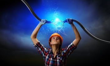 A woman bringing 2 energized ends of a cable together