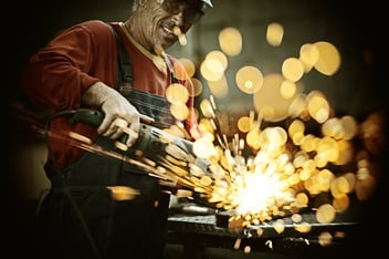 A welder with sparks flying about