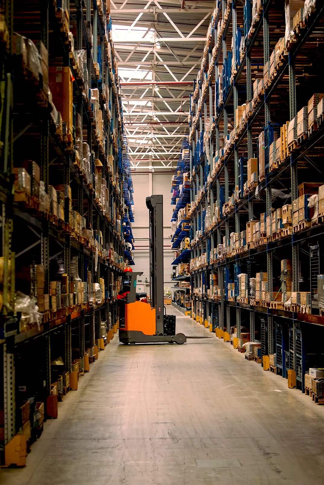 A forklift in a warehouse surrounded by boxes