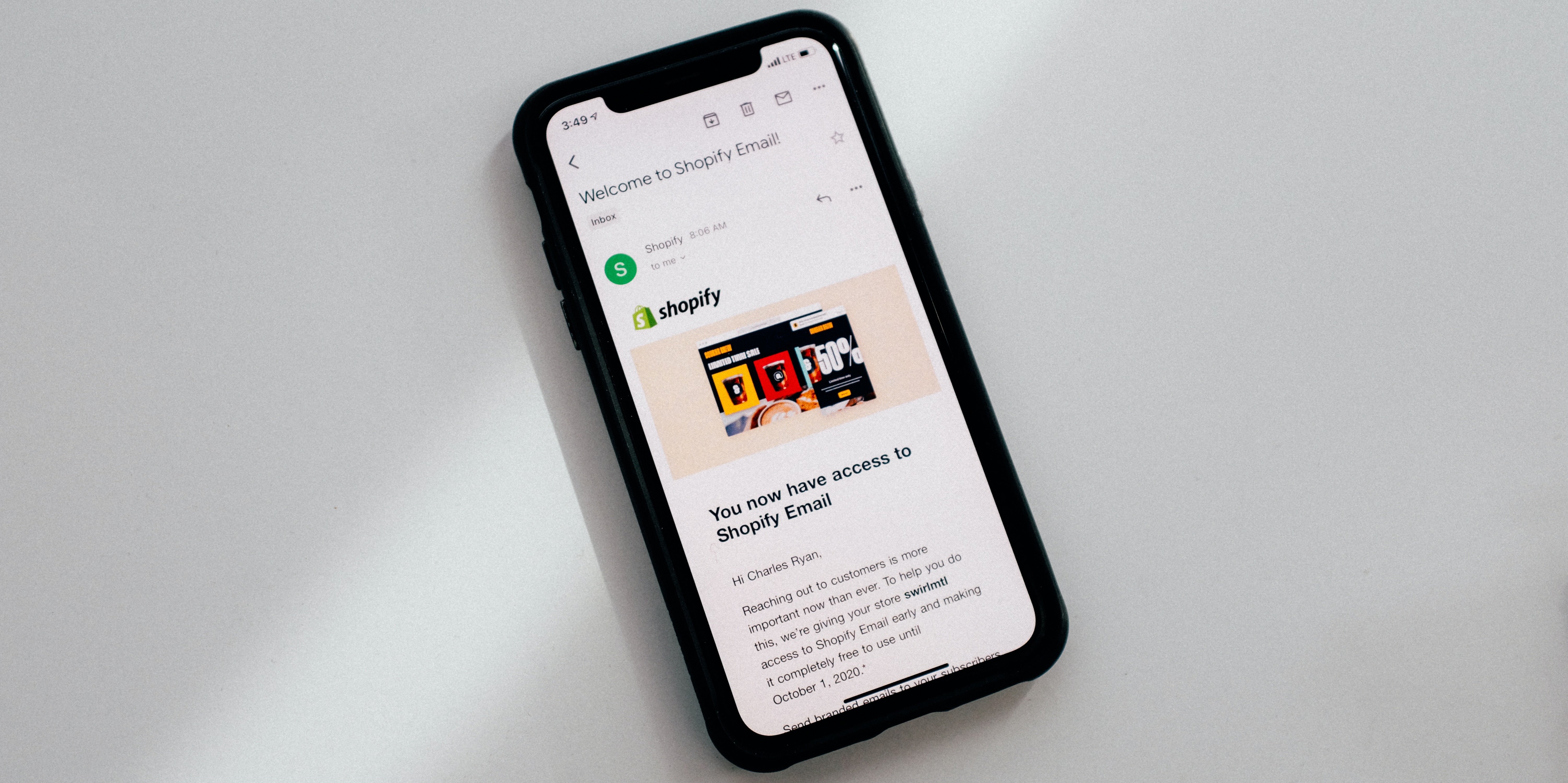 A mobile phone with an email from Shopify shown
