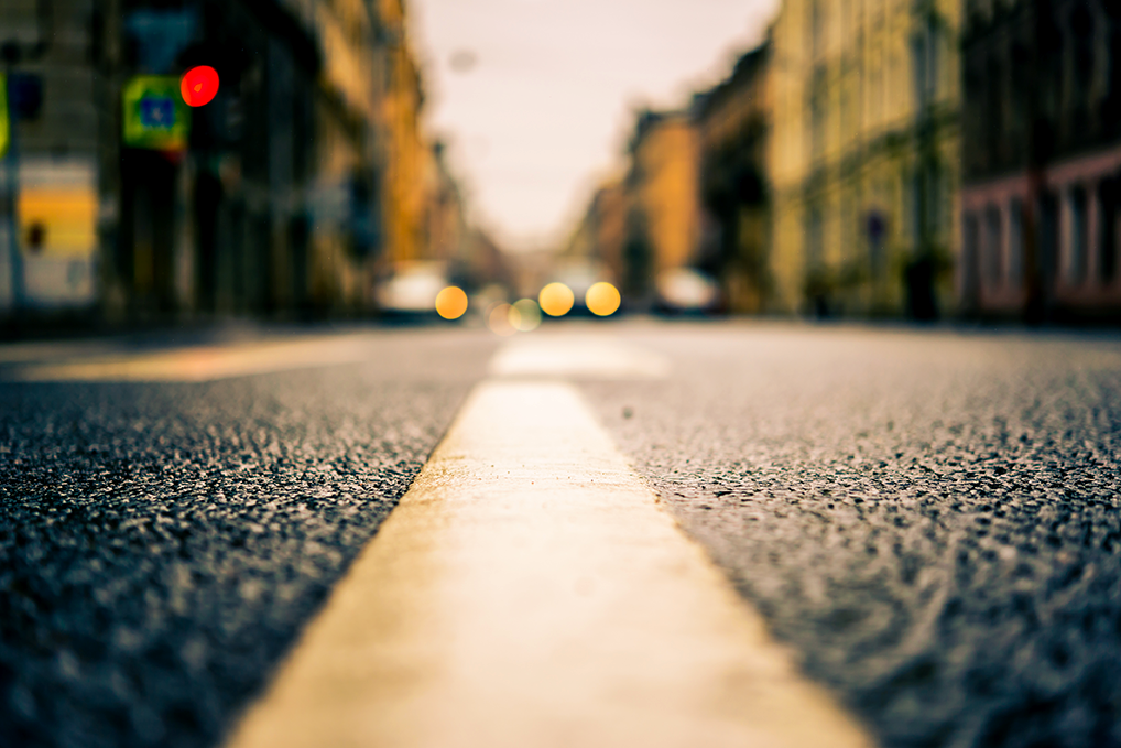 A close shot of a the yellow line down the middle of a road